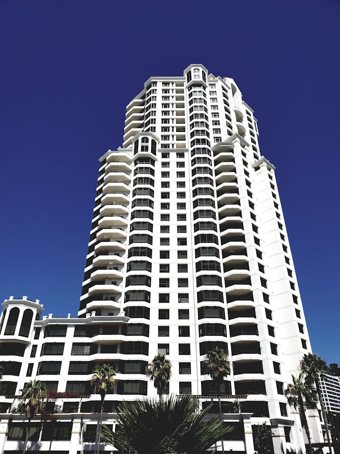 A modern skyscraper with unique architectural design set against a clear blue sky.